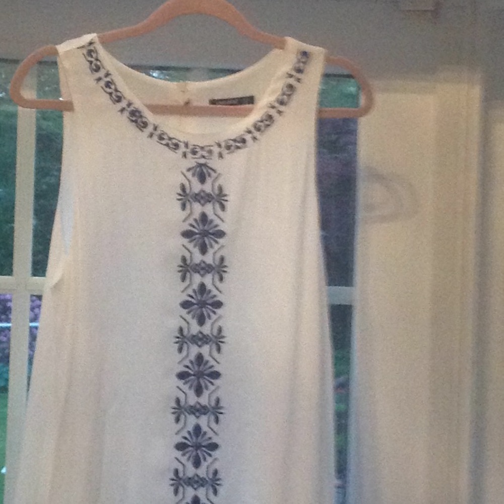 White sleeveless dress with rich blue stitching